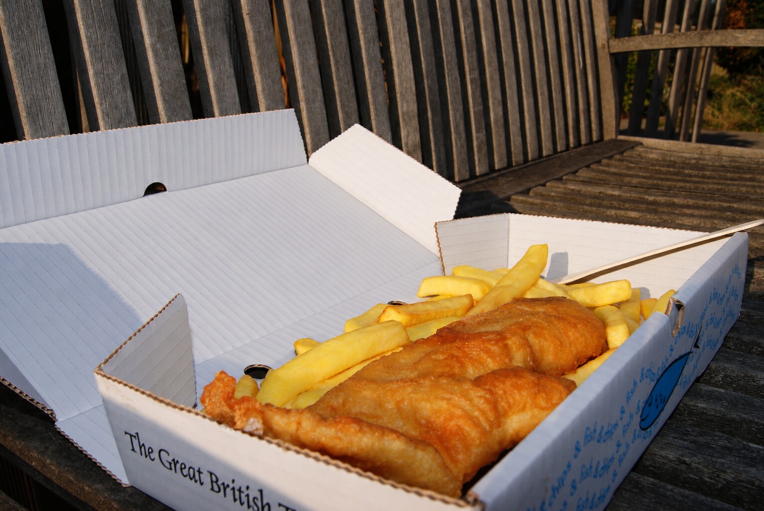 Freshly cooked fish and chips in a traditional box